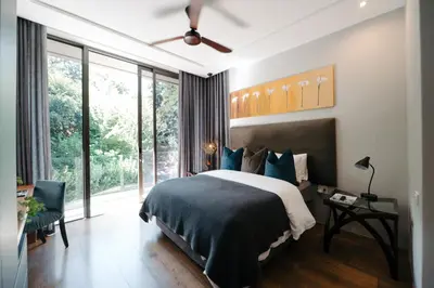 a bedroom with a bed and a large window at Amour in Pniel