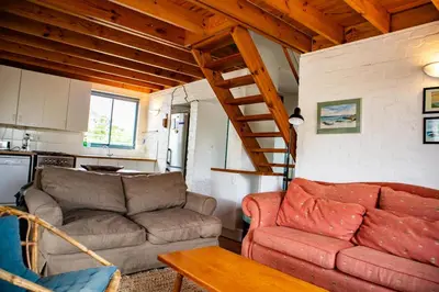a living room with a couch and a table at Bagatelle in Pringle Bay