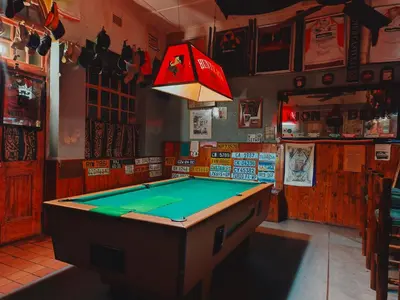 a ping pong table in a bar with a light at The Hermon Hotel in Hermon