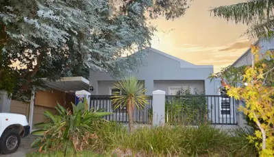 a house with a fence in front of it at 2-Bedroom Private Garden Flat, Durbanville in Durbanville