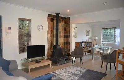 a living room with a tv and a fireplace at 2-Bedroom Private Garden Flat, Durbanville in Durbanville