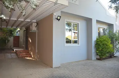 a white house with a white door and a window at 2-Bedroom Private Garden Flat, Durbanville in Durbanville