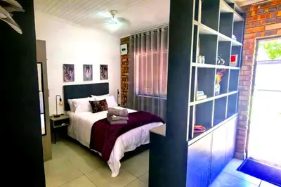 a bedroom with a bed and a book shelf at Bed and Biscuits in Windmeul
