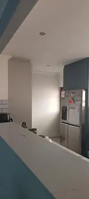 an empty room with a refrigerator and a counter at Accomodation in Cape Town in Goodwood