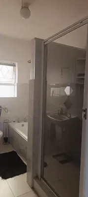 a bathroom with a shower and a tub and a sink at Accomodation in Cape Town in Goodwood