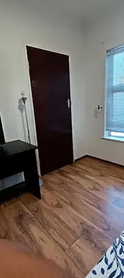 an empty room with a door and a wooden floor at Accomodation in Cape Town in Goodwood
