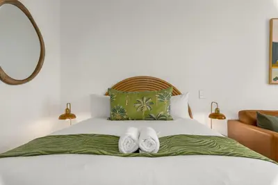 a bedroom with a bed with two towels on it at Bridgewater One 206 in Cape Town
