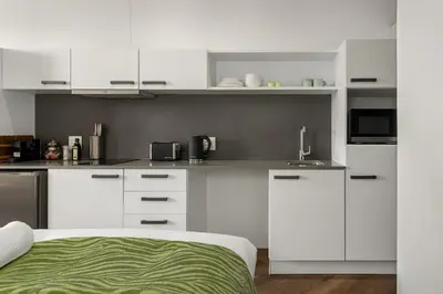 a white kitchen with white cabinets and a sink at Bridgewater One 206 in Cape Town