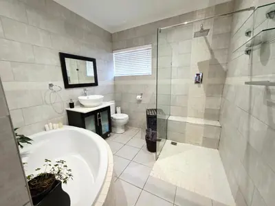 a bathroom with a tub and a sink and a shower at 22 on Breezand in Cape Town