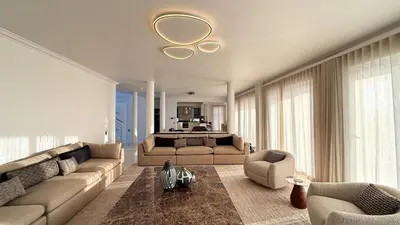 a large living room with a couch and a bed at The Sunset Edition in Cape Town