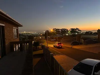 a car driving down a street at sunset at Plattekloof guest house in Tygerberg Hills