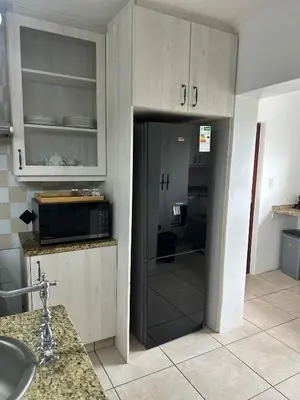 a kitchen with a sink and a microwave at Plattekloof guest house in Tygerberg Hills