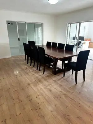 a conference room with a wooden table and chairs at Plattekloof guest house in Tygerberg Hills