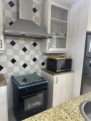 a kitchen with a stove and a microwave at Plattekloof guest house in Tygerberg Hills