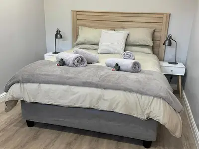 a bedroom with a bed with two stuffed animals on it at Alicante in Worcester