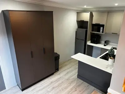 a kitchen with a black refrigerator and a counter at Alicante in Worcester