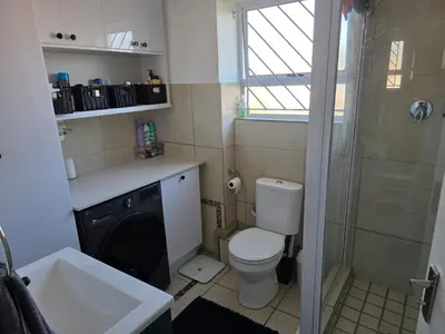 a bathroom with a toilet and a sink and a shower at Secure 2 Bedroom Ground Floor Apartment in Joostenberg Vlakte
