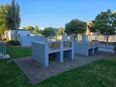 a group of benches sitting in a yard at Secure 2 Bedroom Ground Floor Apartment in Joostenberg Vlakte
