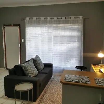 a living room with a couch and a table at Sune's self catering 2 in Worcester