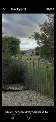 a gate with a fence with a playground behind it at Nerf-af Cottage at Onrus, Hermanus in Hermanus