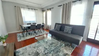 a living room with a couch and a table with chairs at B3 bnb House
