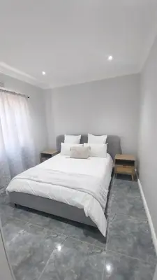 a bedroom with a large bed with white sheets and pillows at B3 bnb House