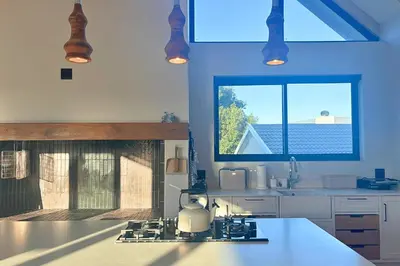 a kitchen with a sink and a counter with a window at Modern 4BDR Flaming Bay in Hermanus in Hermanus