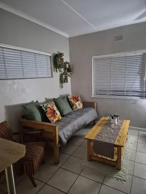 a living room with a couch and a table at Suné's Self Catering 1 in Worcester