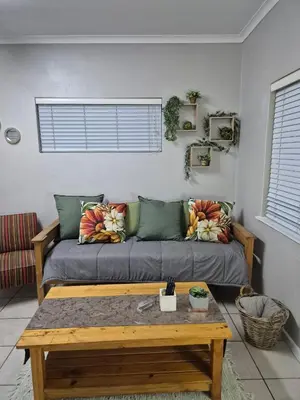 a living room with a couch and a coffee table at Suné's Self Catering 1 in Worcester