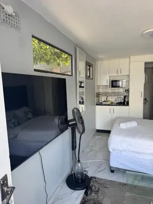 a room with two beds and a lamp in it at Legacy lodge in Goodwood