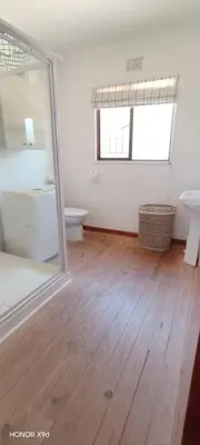 a white bathroom with a toilet and a sink at Pet Friendly Sandbaai in Hermanus