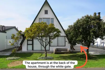a house with a red arrow pointing at the back of the house at Protea Escape - Apartment in Hermanus