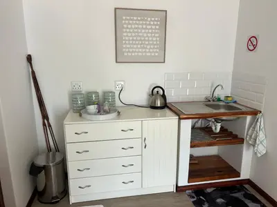 a kitchen with a sink and a counter at Protea Escape - Apartment in Hermanus