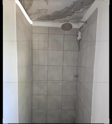 a bathroom with a tiled shower with a ceiling at Escape Root in Caledon