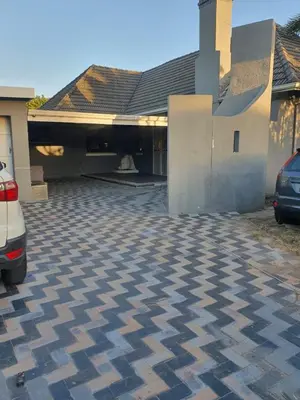 a house with a car parked in a driveway at Ludinz Self Catering Guest House