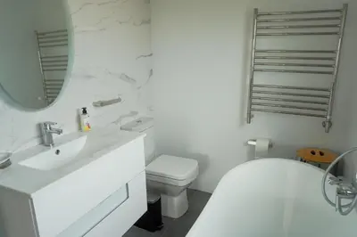 a white bathroom with a sink and a toilet at Leah's View in Pringle Bay