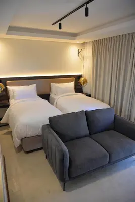 a living room with two beds and a couch at Misasa on Orchard in Cape Town