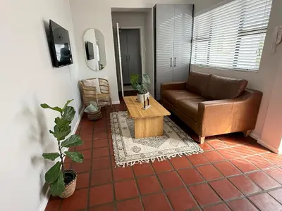 a living room with a couch and a coffee table at Die Stal in Wellington
