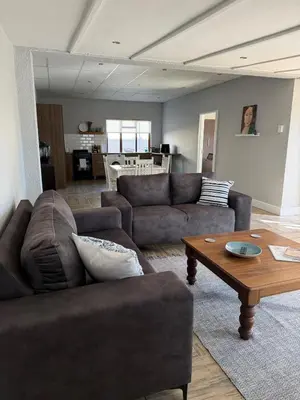 a living room with two couches and a coffee table at Fijnbos in Strand