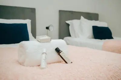a bed with a bar of soap and a razor on it at Sea Facing 2 Bedroom Apartment In Burmeister On Park, Milnerton in Cape Town