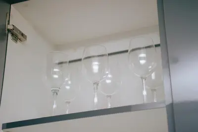 a row of wine glasses sitting on a shelf at Sea Facing 2 Bedroom Apartment In Burmeister On Park, Milnerton in Cape Town
