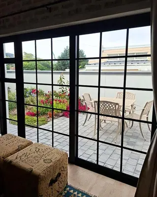 a view of a patio from a room with a window at Bird's Landing in Hermanus