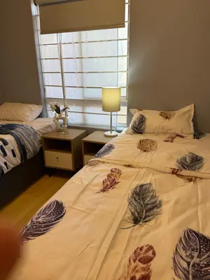 a bedroom with two beds and a window at Cozy Apartment with Table Mountain and beach views in Cape Town
