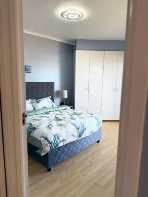 a bedroom with a bed and a blue wall at Cozy Apartment with Table Mountain and beach views in Cape Town