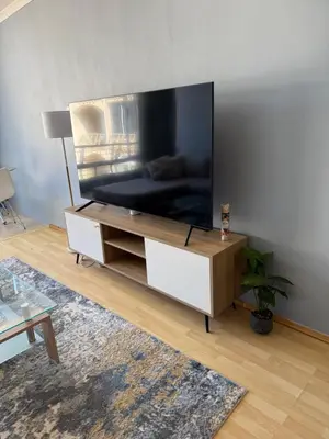 a living room with a large flat screen tv at Cozy Apartment with Table Mountain and beach views in Cape Town