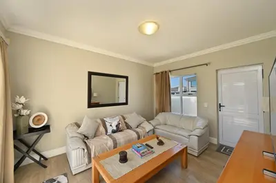 a living room with a couch and a table at The lodge in Cape Town