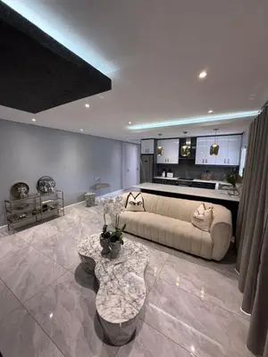 a living room with a couch and a table at Canal Walk Luxury 2 Bedroom Apartments in Cape Town