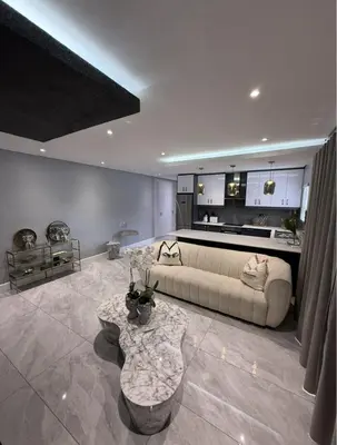 a living room with a couch and a table at Canal Walk Luxury 2 Bedroom Apartments in Cape Town