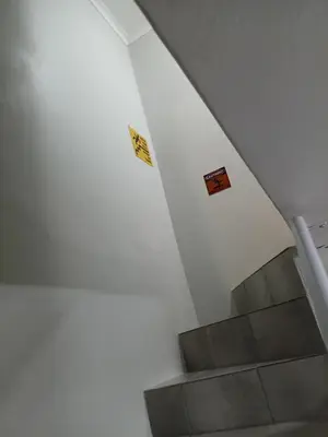 a stairway with signs on the walls and a staircase at Coastal Guest House with Free Parking and Braai Area in Cape Town