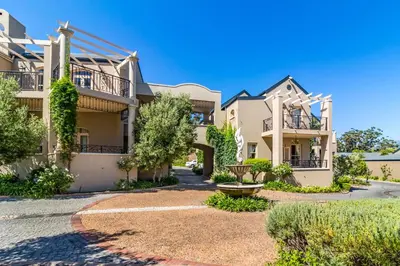 a large apartment building with a courtyard at L'Ermitage Chateau and Villas at Villa 80 in Franschhoek
